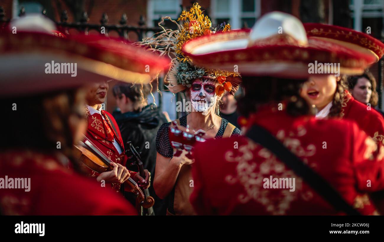 Mariachi Las Adelitas si presenta faccia a faccia con un personaggio di Día de los Muertos. Foto Stock