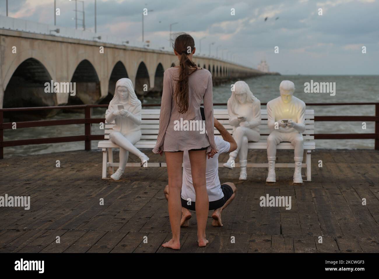 I visitatori scattano foto di fronte all'installazione della scultura "Absorbed by Light" progettata dal Gala britannico di maggio Lucas e realizzata dallo scultore berlinese Karoline Hinz, a Progreso. Martedì 23 novembre 2021, a Progreso, Yucatan, Messico. (Foto di Artur Widak/NurPhoto) Foto Stock