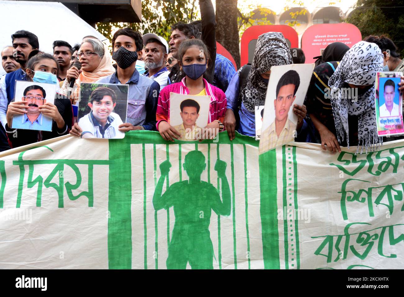 I parenti tengono ritratti dei loro familiari scomparsi mentre formano una catena umana durante la Giornata internazionale dei diritti umani, a Shahbagh a Dhaka, Bangladesh, il 10 dicembre 2021. Il rally della catena umana è organizzato dalla piattaforma Mayer Daak (Mother's Call). I parenti delle vittime della sparizione forzata hanno chiesto il ritorno dei loro cari in occasione della Giornata internazionale dei diritti umani. (Foto di Mamunur Rashid/NurPhoto) Foto Stock