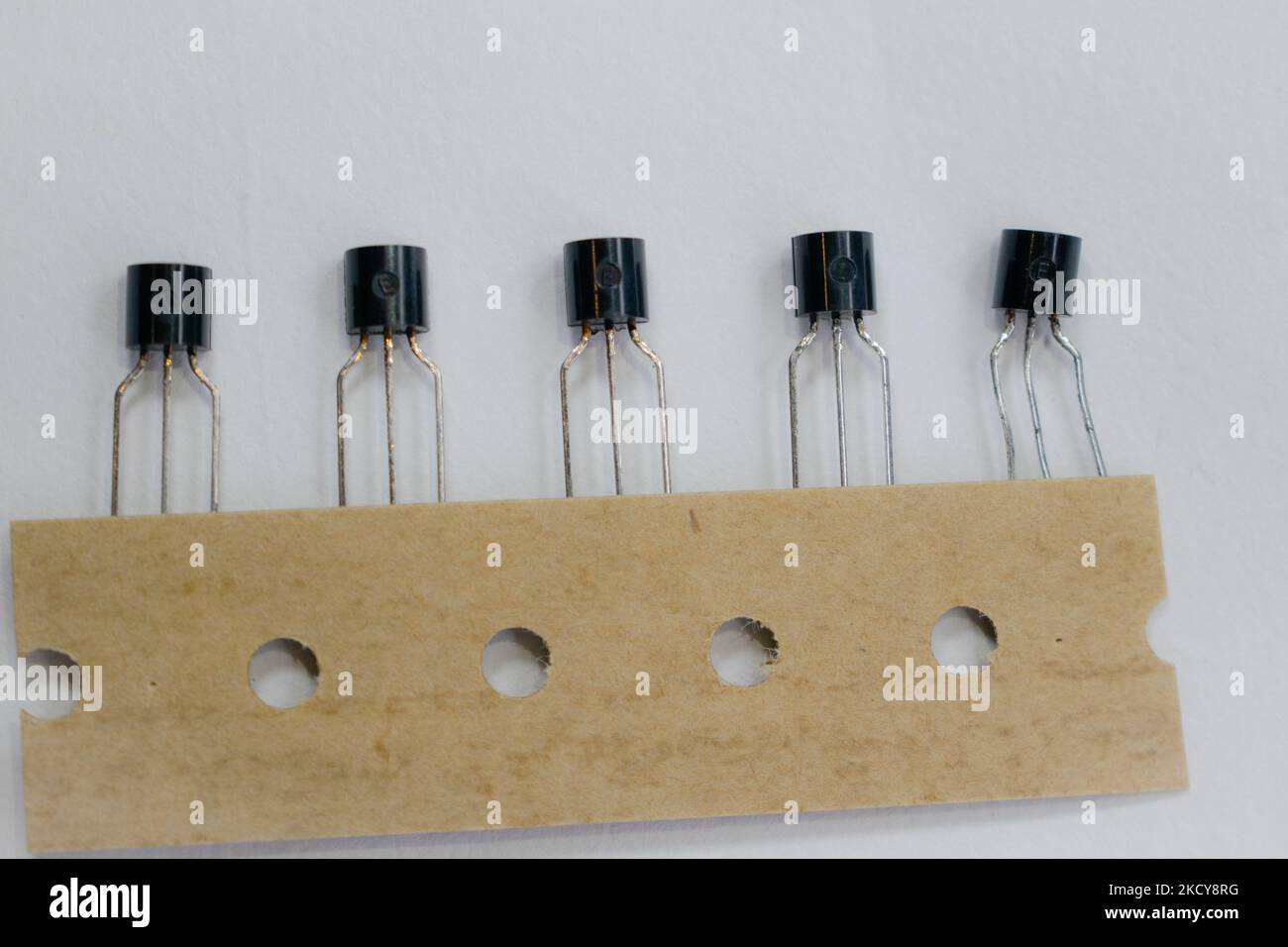 fila di transistor elettronici isolati su sfondo bianco con spazio di copia. transistor a 3 pin isolati. Transistor NPN e PNP isolati Foto Stock