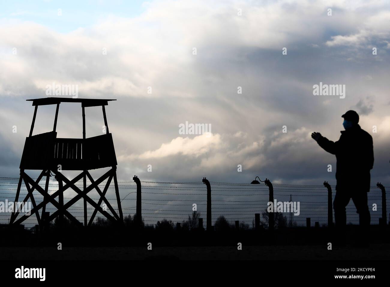 Un visitatore passa accanto ad una torre di guardia presso l'ex campo di concentramento tedesco nazista Auschwitz II-Birkenau a Brzezinka, vicino Oswiecim, Polonia, il 3 gennaio 2022. (Foto di Jakub Porzycki/NurPhoto) Foto Stock