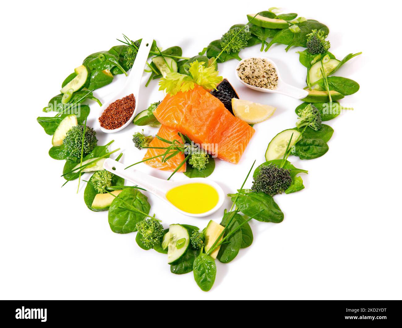 Insalata verde a forma di cuore e verdure con salmone grezzo isolato Su sfondo bianco Foto Stock