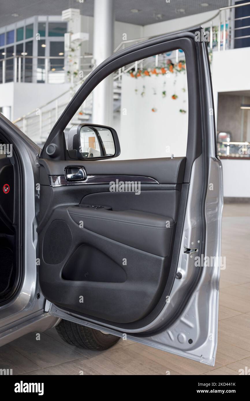Russia, Izhevsk - 4 marzo 2022: Showroom Jeep. Interno del nuovo Grand Cherokee fuoristrada con porta passeggero aperta. Marchio famoso in tutto il mondo. Trasporto Foto Stock