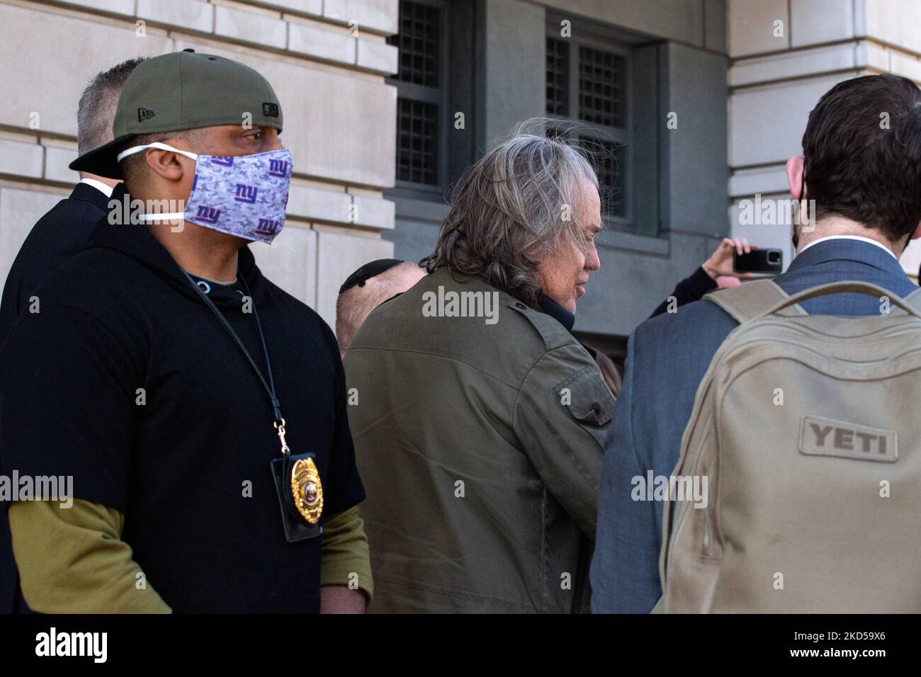 Una guardia di sicurezza si trova dietro l'ex stratega Trump Steve Bannon mentre parla ai media al di fuori del E. Barrett Prettyman United States Federal Courthouse a Washington, D.C. il 16 marzo 2022 (Photo by Bryan Olin Dozier/NurPhoto) Foto Stock