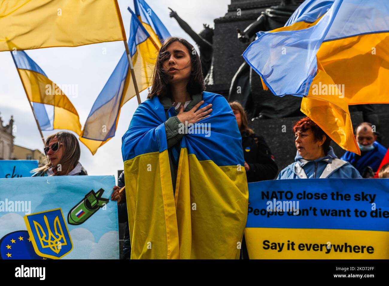 Cittadini e sostenitori ucraini cantano inno ucraino mentre assistono a una dimostrazione di solidarietà con l'Ucraina nella piazza principale, chiedendo alla NATO di chiudere il cielo per gli aerei russi sul territorio dell'Ucraina a seguito dell'invasione russa. Cracovia, Polonia il 7 aprile 2022. (Foto di Beata Zawrzel/NurPhoto) Foto Stock