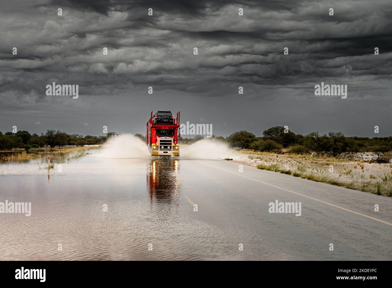 Road Train su una Great Northern Highway allagata nell'Outback australiano. Foto Stock