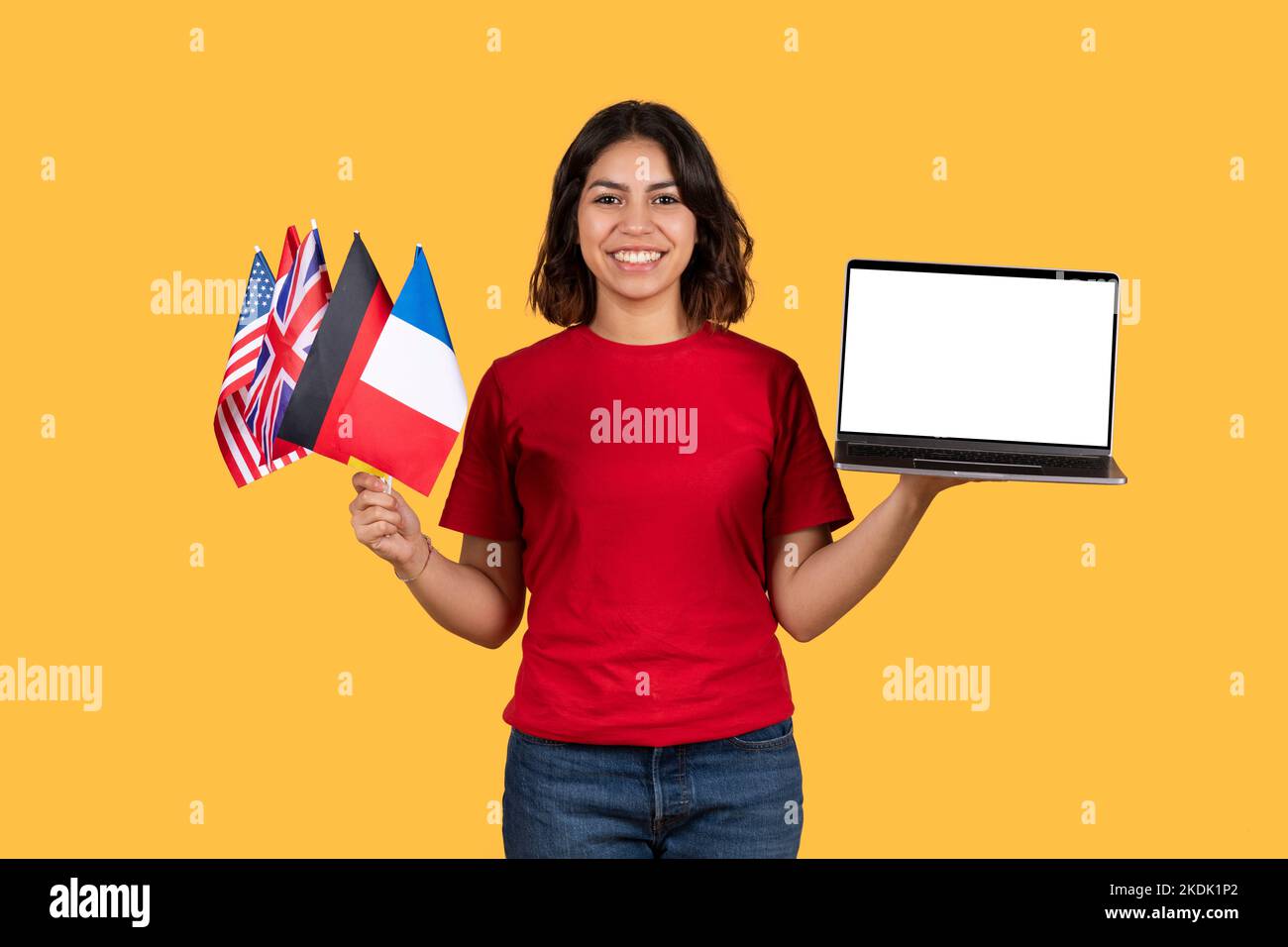 Felice studente medio-orientale con bandiere diverse e notebook Foto Stock