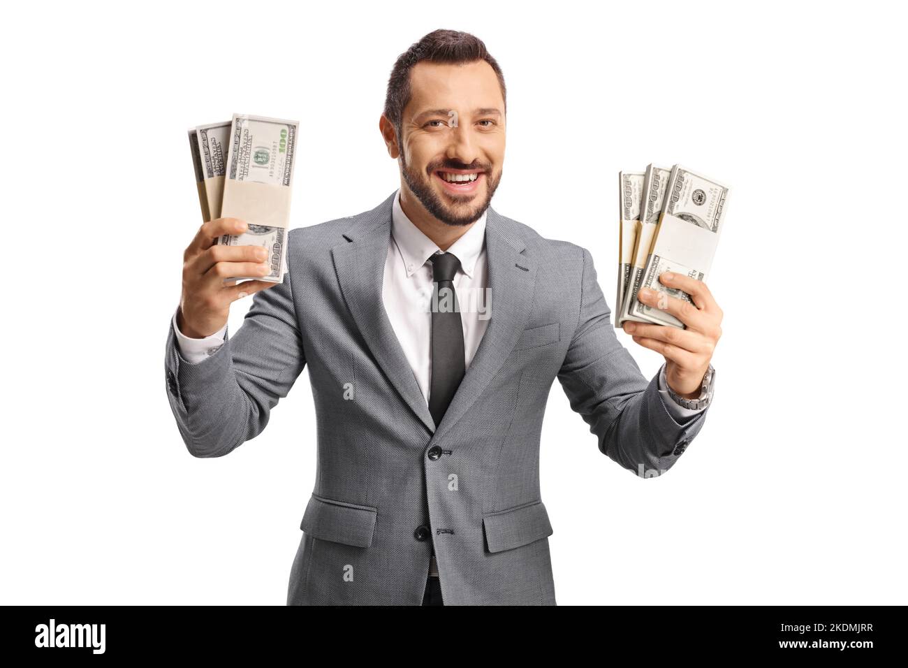 Giovane uomo d'affari di successo che tiene i soldi e sorridente isolato su sfondo bianco Foto Stock