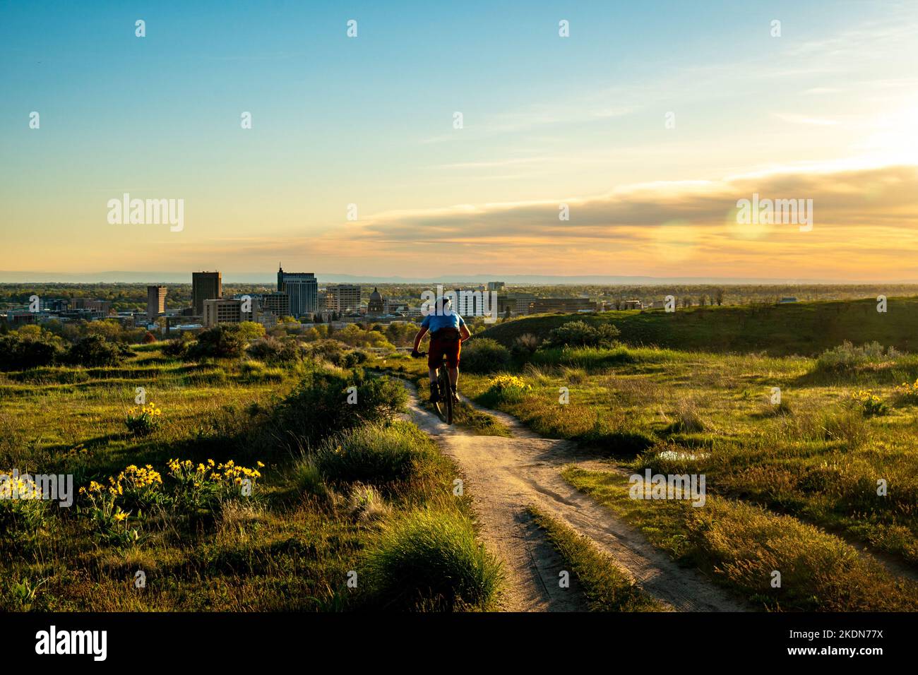 Mountain Biker prendere un po 'di aria nella zona della Riserva militare ai piedi delle Boise Foothills al tramonto. Foto Stock
