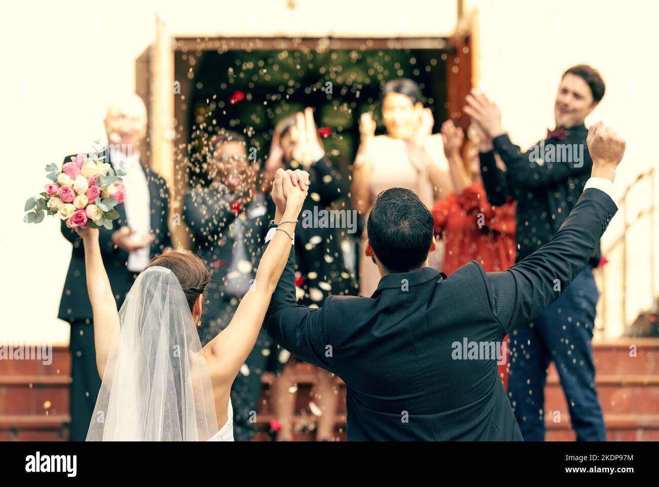 Matrimonio, applausi e coppia in festa con il sostegno di ospiti, amici e familiari. Vista posteriore, sposa e sposo celebrare Foto Stock