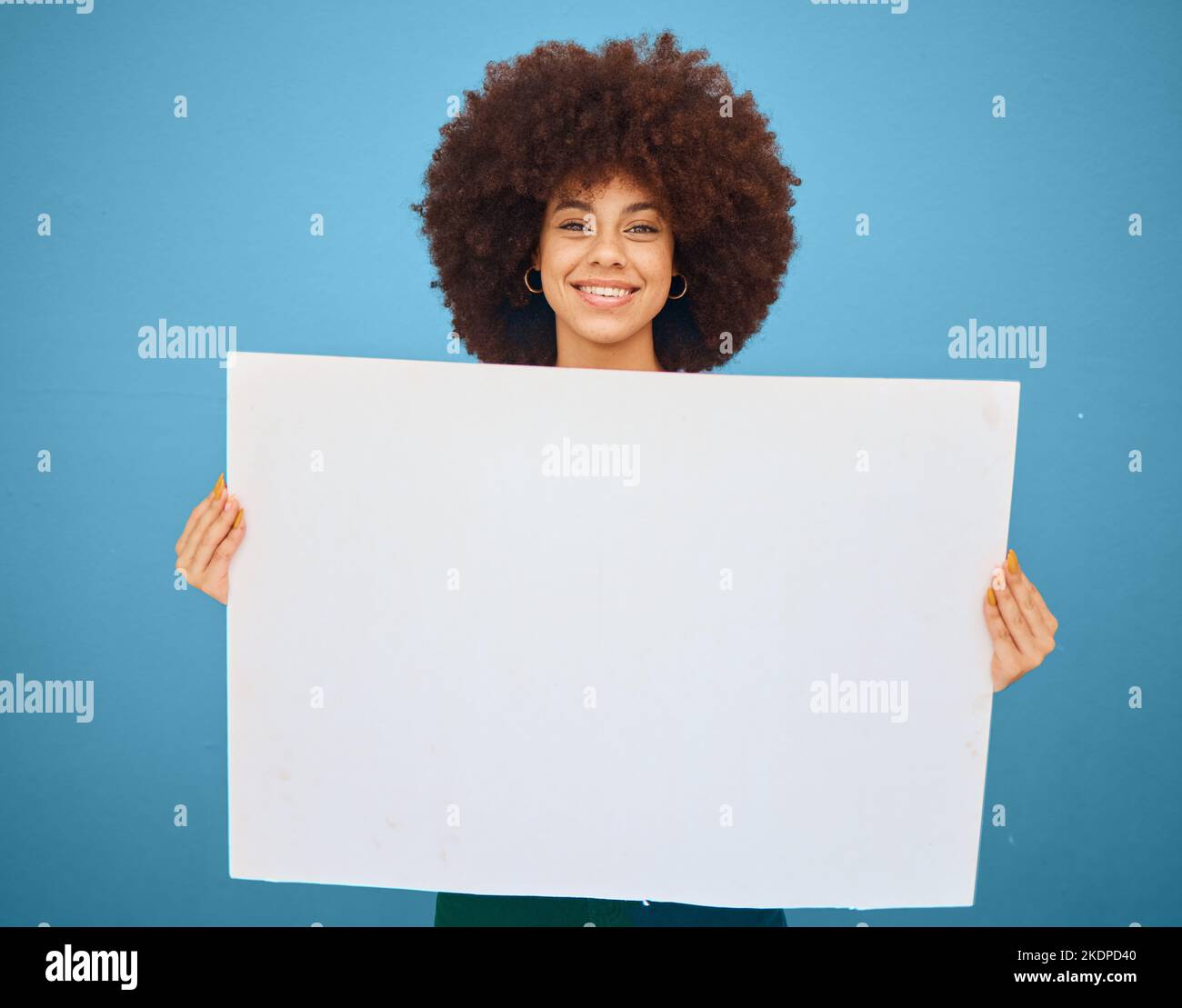 Pubblicità, mockup e donna con un poster per il marketing, il business creativo e il branding su uno sfondo blu studio. Logo, comunicazione e. Foto Stock