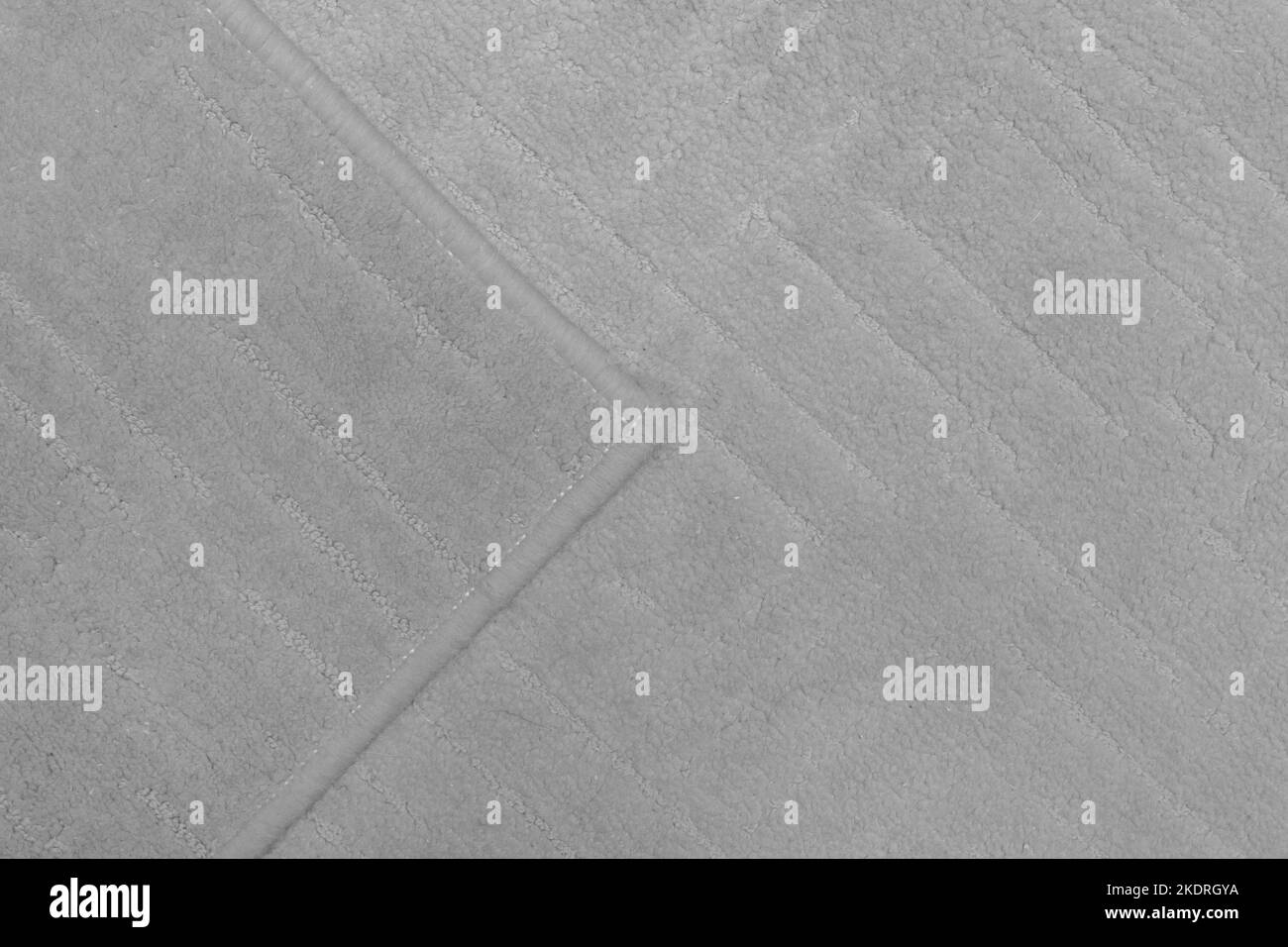 Dettaglio tappeto frammento di tessuto per pavimento in materiale grigio per la texture della superficie della parte di disegno. Foto Stock