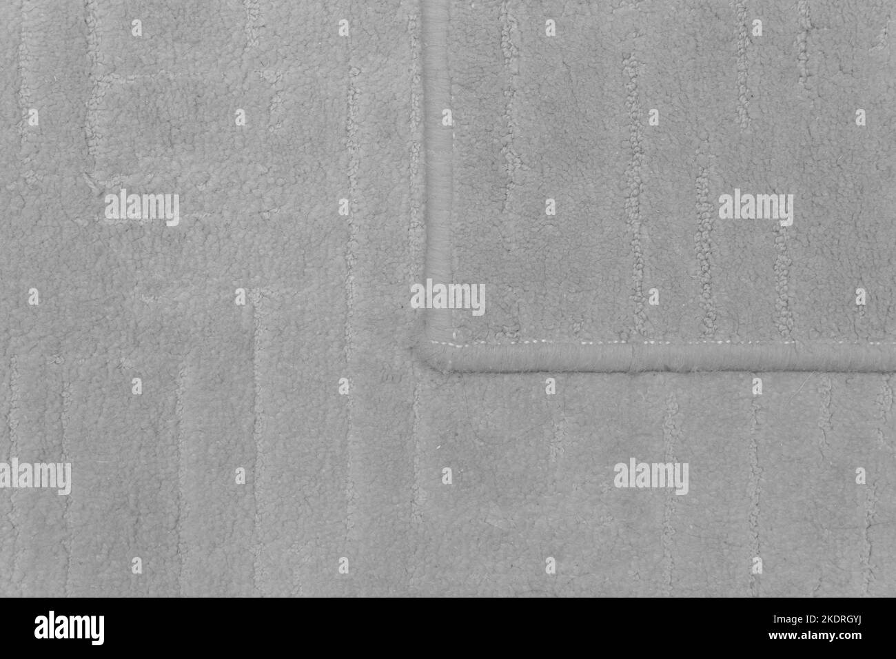 Dettaglio tappeto frammento di tessuto per pavimento in materiale grigio per la texture della superficie della parte di disegno. Foto Stock