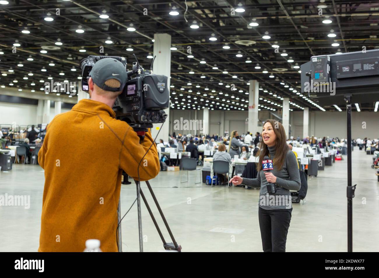 Detroit, Michigan, Stati Uniti. 8th Nov 2022. Un giornalista televisivo riferisce come gli addetti alle elezioni della città di Detroit contano le urne assentee il giorno delle elezioni nel centro congressi della città. Un giorno prima, un giudice ha lanciato la causa del candidato repubblicano Kristina Karamo, chiedendo che tutte le schede elettorali assentee lanciate a Detroit siano squalificate. Il giudice del circuito capo della contea di Wayne Timothy Kenny ha stabilito che la causa di Karamo mancava di “qualsiasi prova” di violazioni della legge elettorale. Credit: Jim West/Alamy Live News Foto Stock