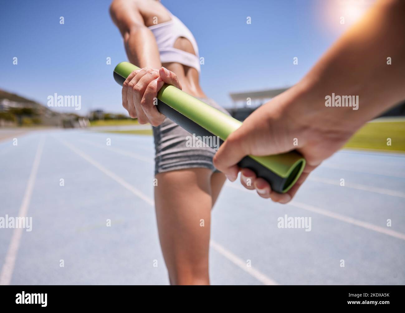 Staffetta maratona, batone e donna runner che corrono su pista all'interno di stadio atletico, arena sportiva e campo da corsa. Allenamento di squadra cardio Foto Stock