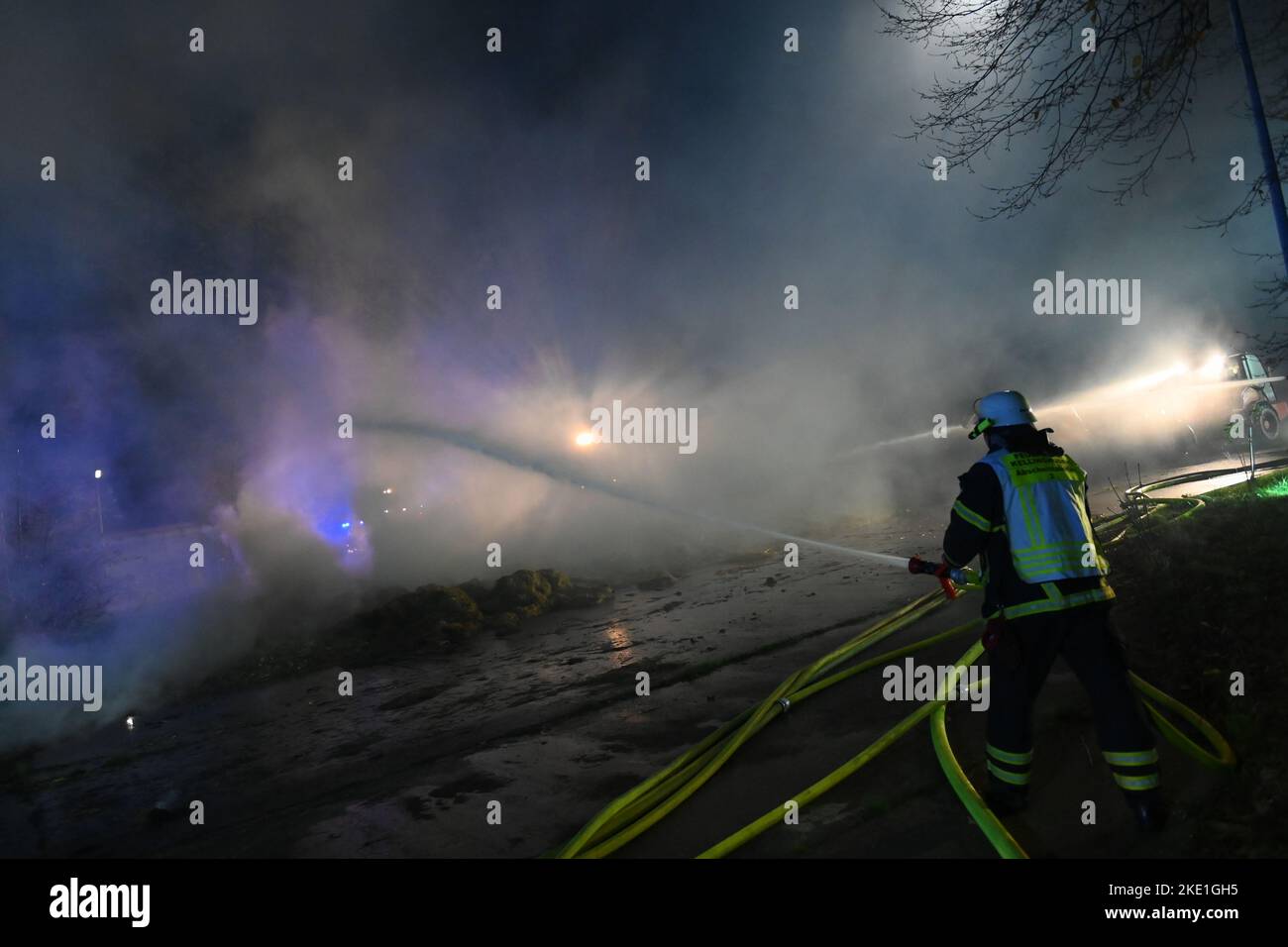 Kellinghusen, Germania. 09th Nov 2022. Un vigile del fuoco si spegne nel denso fumo dell'incendio. A Kellinghusen (distretto di Steinburg), una sala con un tetto ha preso fuoco su un ex caserma. Credit: Jonas Walzberg/dpa/Alamy Live News Foto Stock