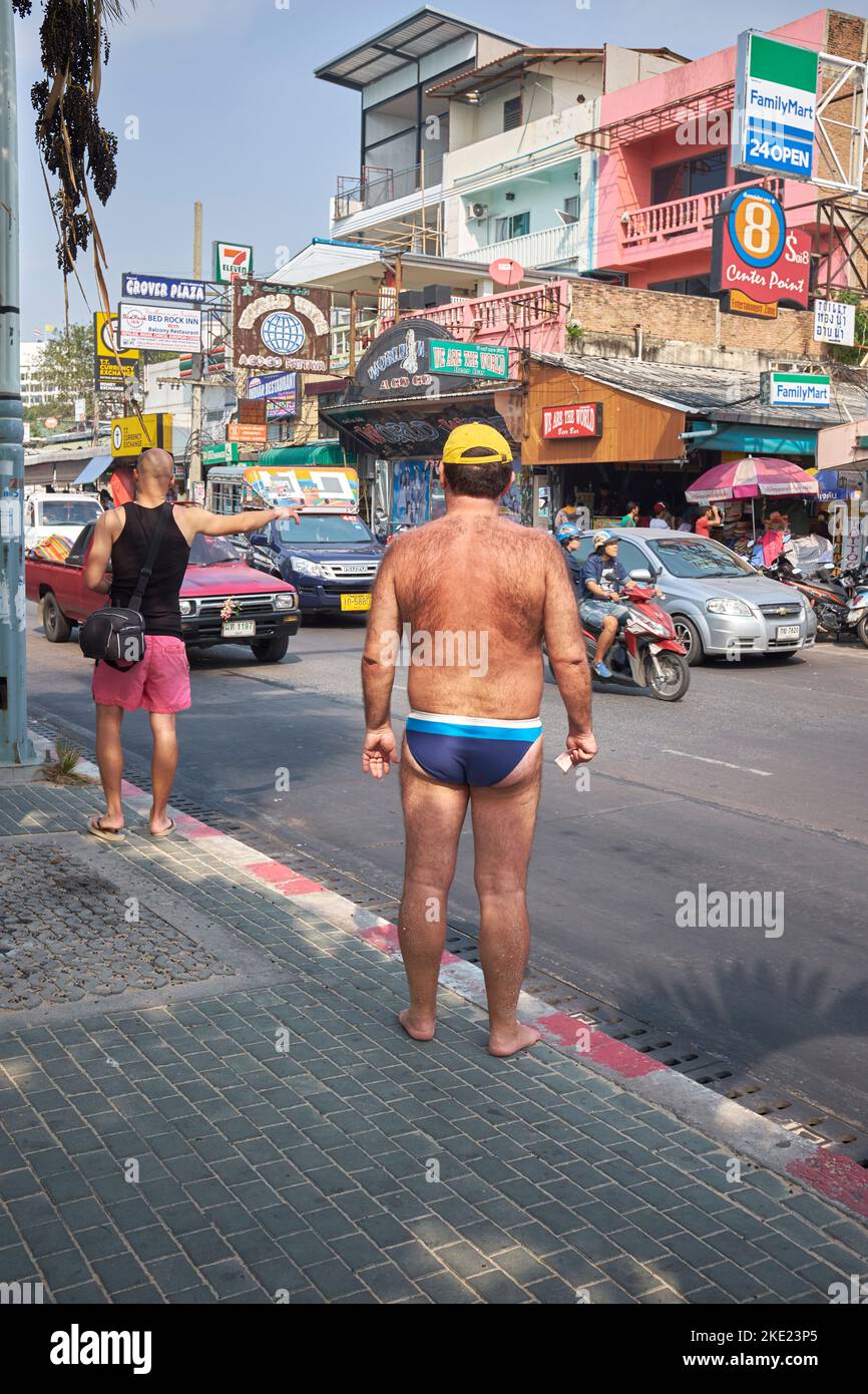 Turista occidentale in costume da bagno per strada a Pattaya, Thailandia Foto Stock