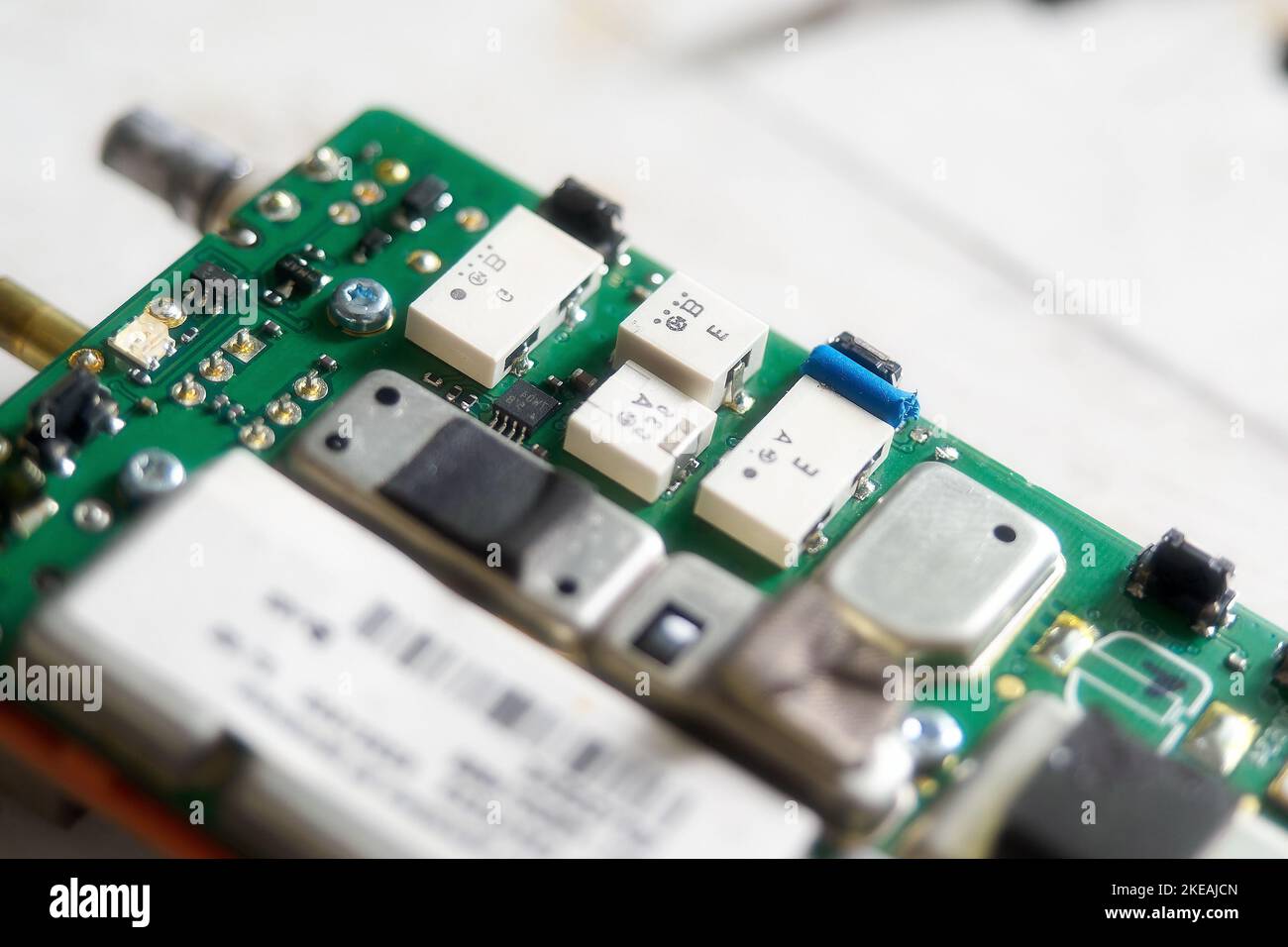 Scheda con chip, chip elettronici, transistor e condensatori in primo piano. Dettaglio del dispositivo elettronico con messa a fuoco selettiva. Sfondo. Importa e sostituisci Foto Stock