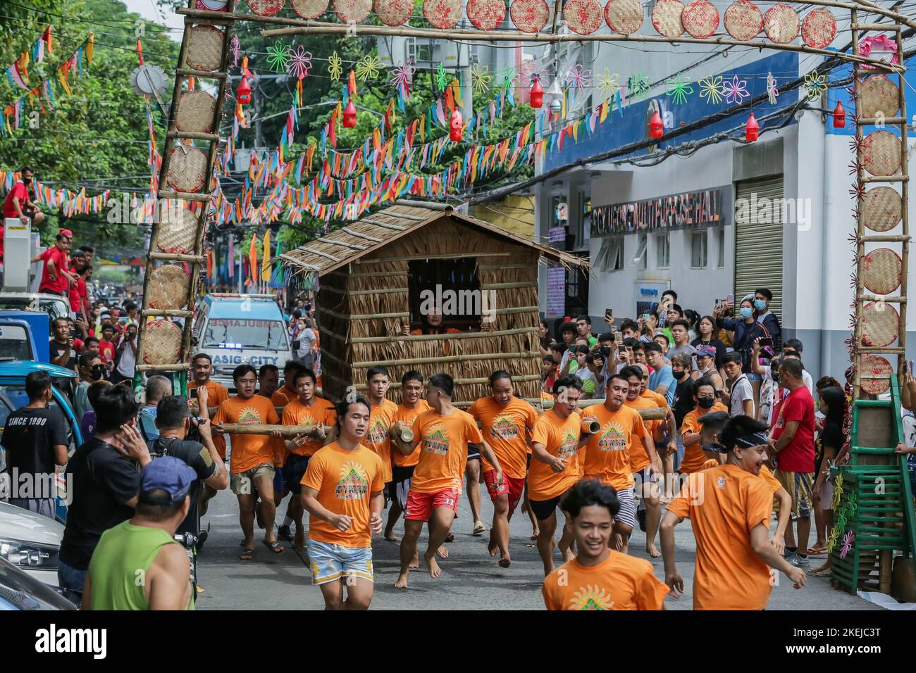 Pasig City, Filippine. 12th Nov 2022. I residenti corrono mentre trasportano una capanna fatta di palma di nipa durante la corsa di Buhat Kubo (che trasporta la capanna di nipa) a Pasig City, le Filippine, 12 novembre 2022. Credit: Rouelle Umali/Xinhua/Alamy Live News Foto Stock