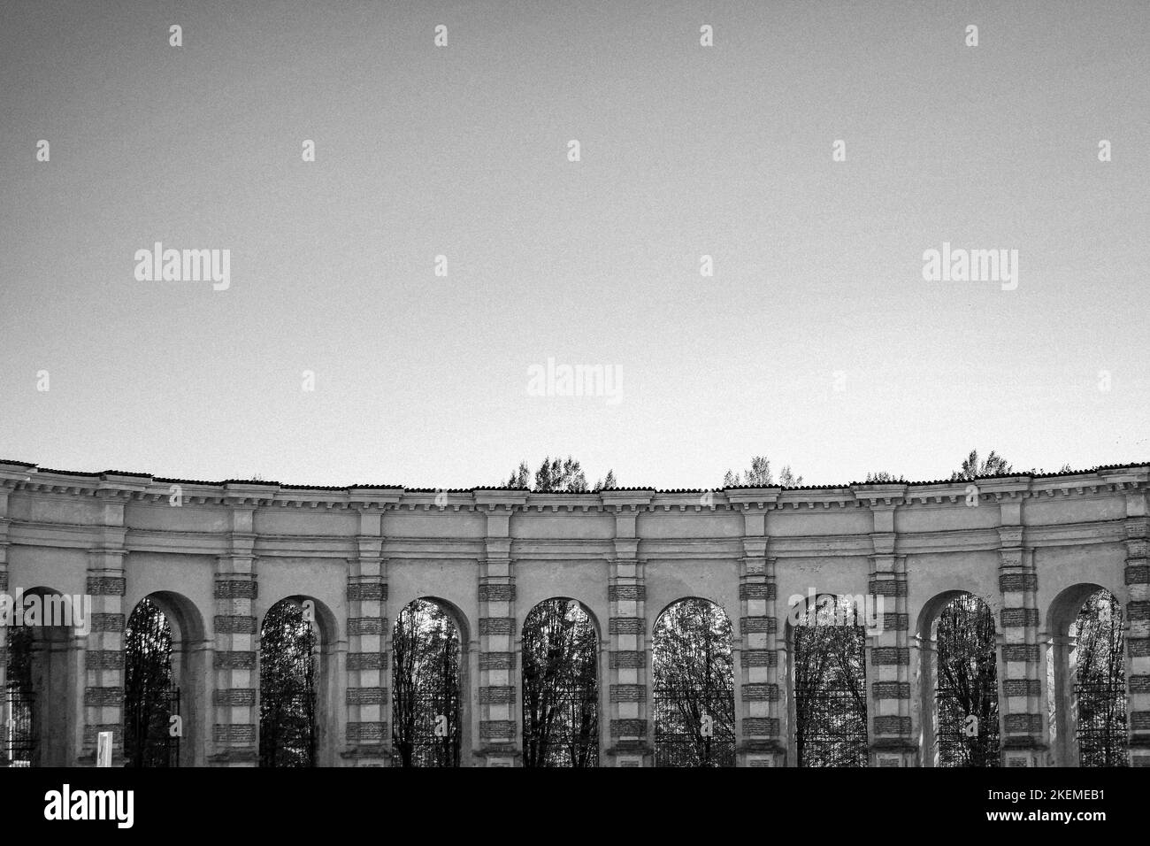 Un arco curvo sotto un cielo blu chiaro in un parco Foto Stock