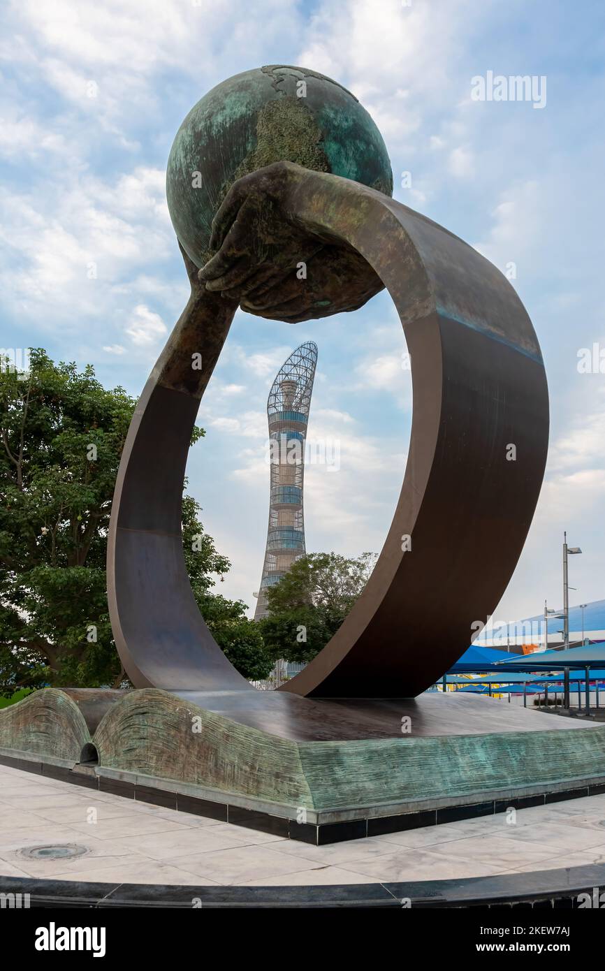 Le mani che si alzano da un libro sostengono il globo in questa scultura all'Aspire Academy del Qatar a Doha. Foto Stock