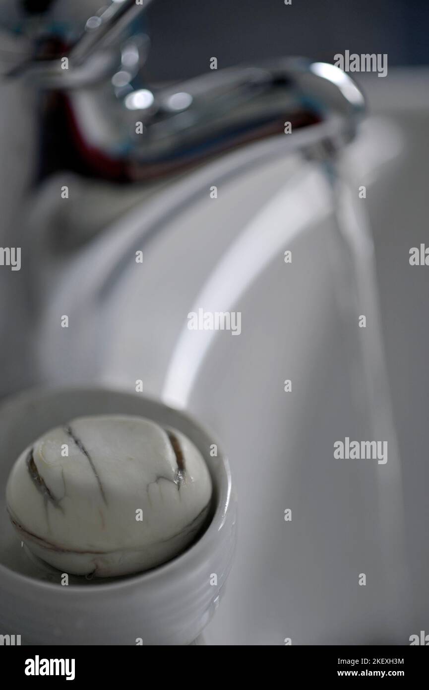 sapone piatto e acqua corrente di rubinetto nel lavabo Foto Stock