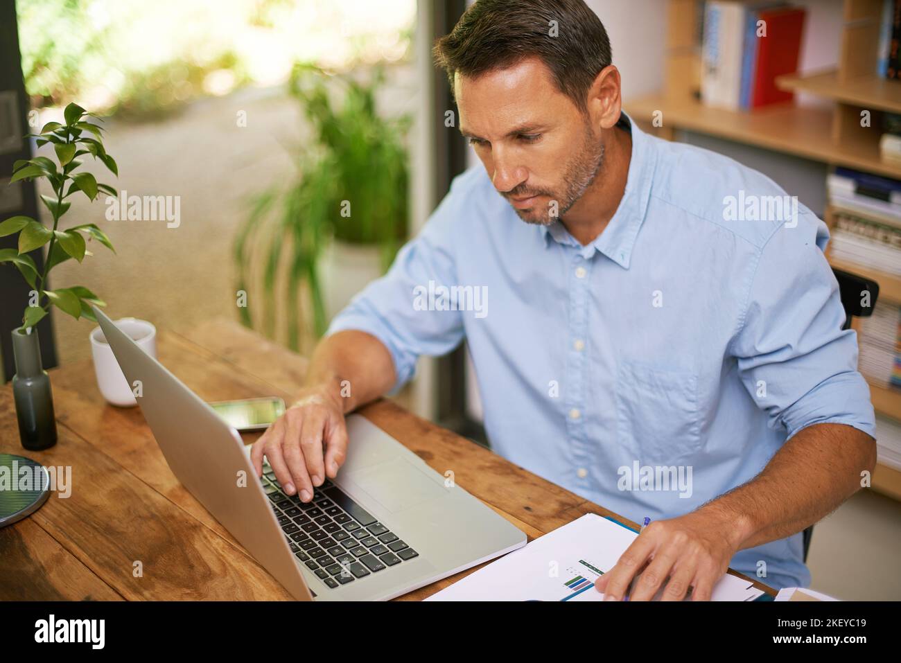 Incrociare tutti i fatti e le figure. Un giovane che lavora da casa. Foto Stock