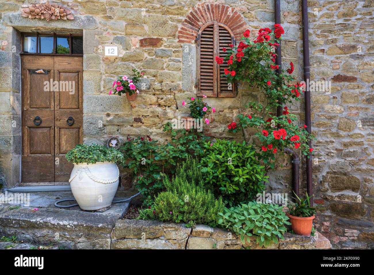 Mostra floreale all'esterno della casa nella città collinare di Cortona in Toscana Foto Stock