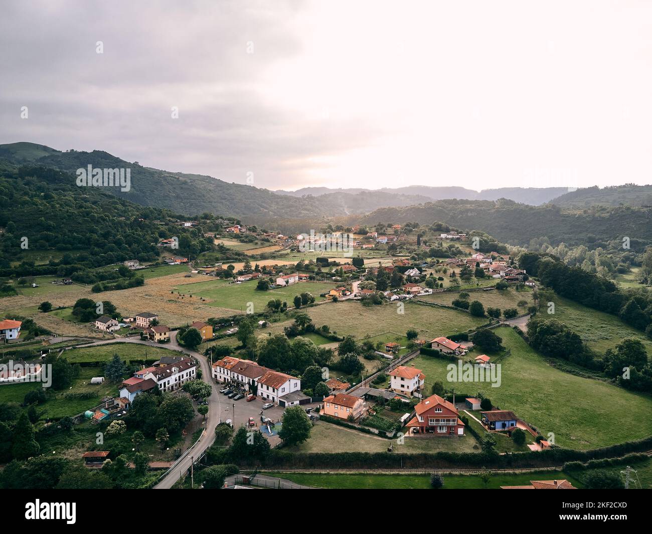 immagine scattata con un drone della bella città tranquilla circondata da campi e vegetazione in una giornata nuvolosa, priorio, spagna Foto Stock