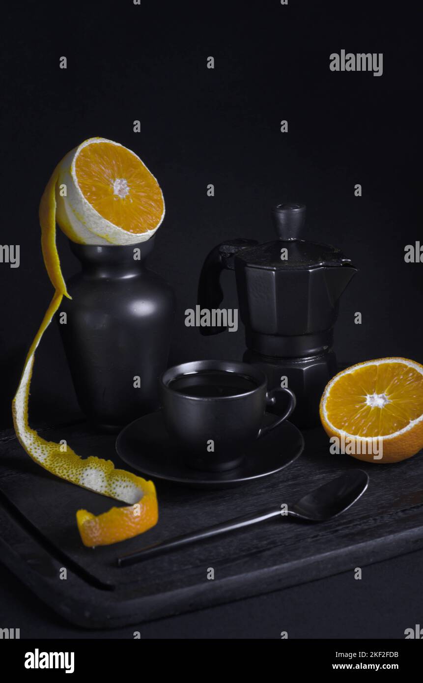 Caffè italiano. Tazza di espresso caldo, moka pot su un asse di legno rustico, sfondo scuro, messa a fuoco selettiva. Natura morta, fotografia scura. Foto Stock