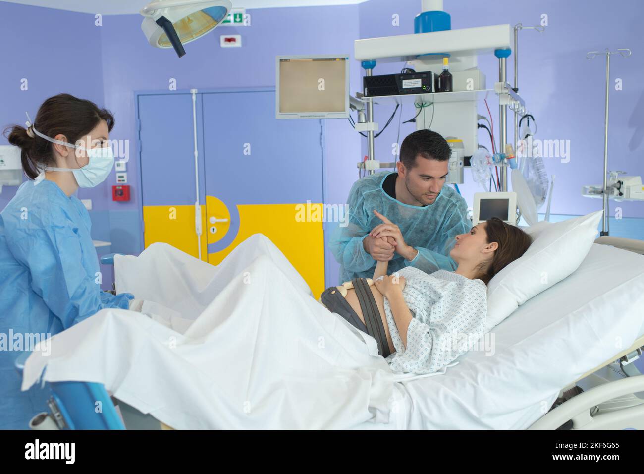 marito e donna che partoriscono in sala operatoria dell'ospedale Foto Stock