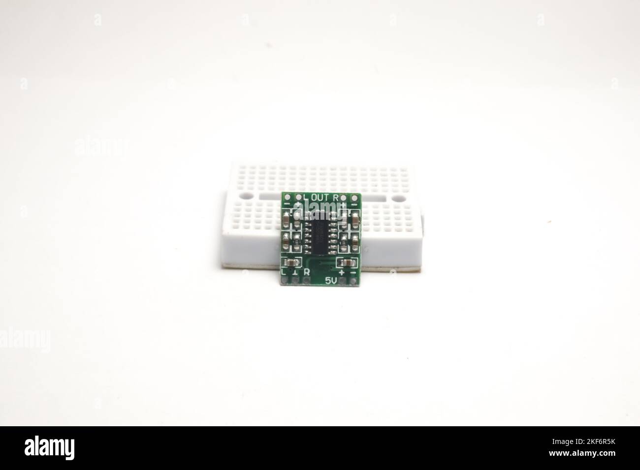 Un piccolo modulo amplificatore audio si appoggia su una scheda di progetto utilizzata come materiale fai da te per l'appassionato di elettronica. Foto Stock