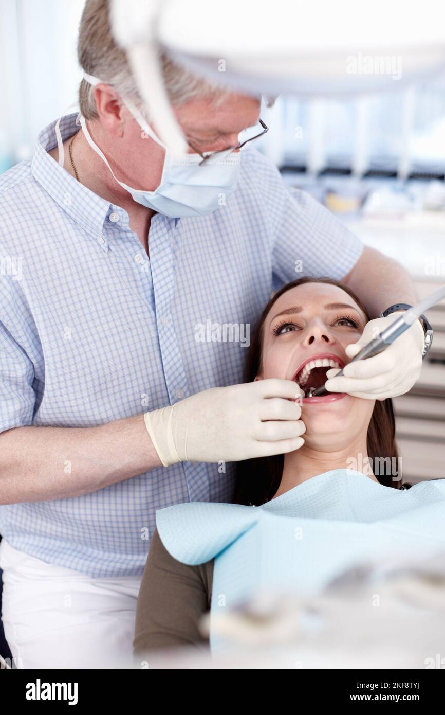 Salute dentale. Ritratto del dentista che lavora sui denti dei pazienti per un sorriso sano. Foto Stock