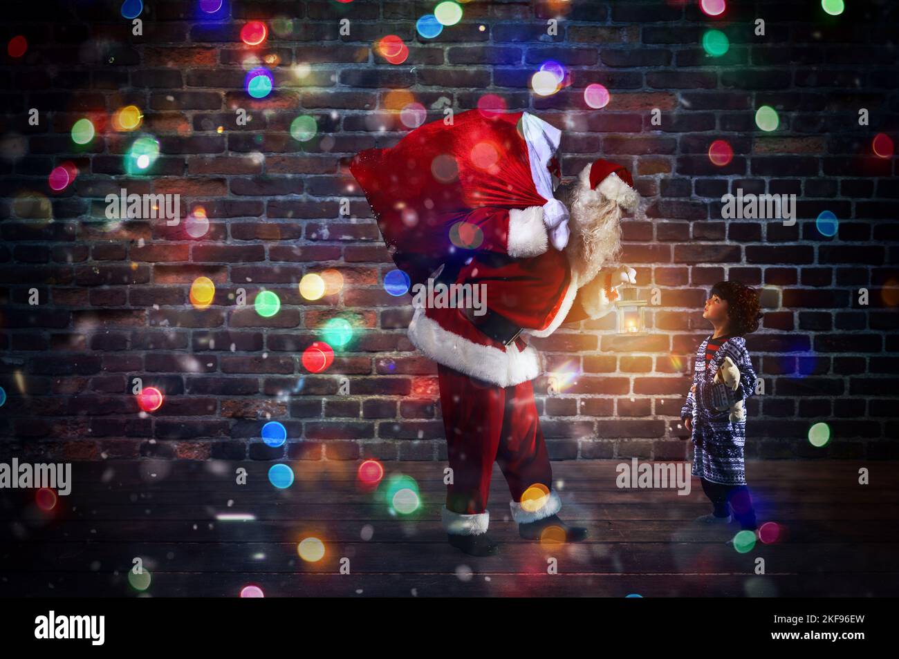 Babbo Natale sta regalando un regalo di Natale a un ragazzino Foto Stock