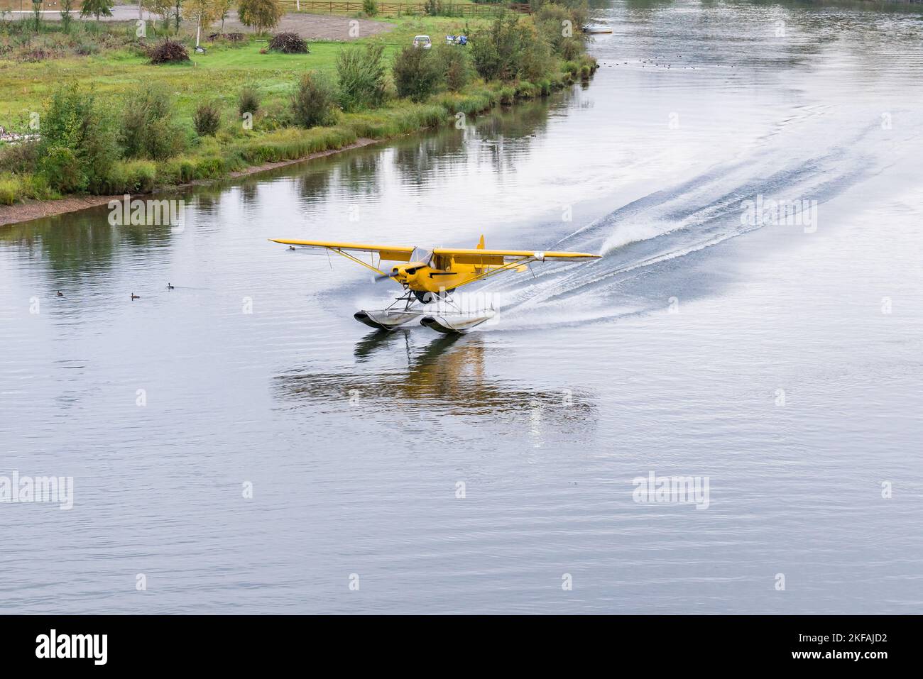 L'aereo galleggiante giallo Bush atterra sul fiume Chena in Alaska Foto Stock
