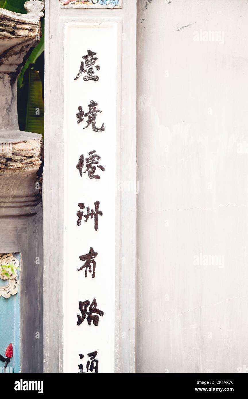 Un'immagine verticale dell'antica scrittura cinese su un tempio buddista bianco Foto Stock