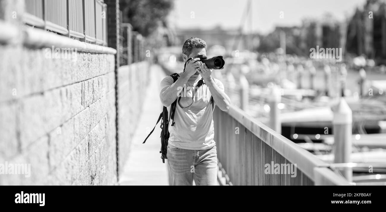 Fotografo di viaggio freelance uomo scattare fotografie utilizzando la fotocamera durante le vacanze estive, la fotografia Foto Stock