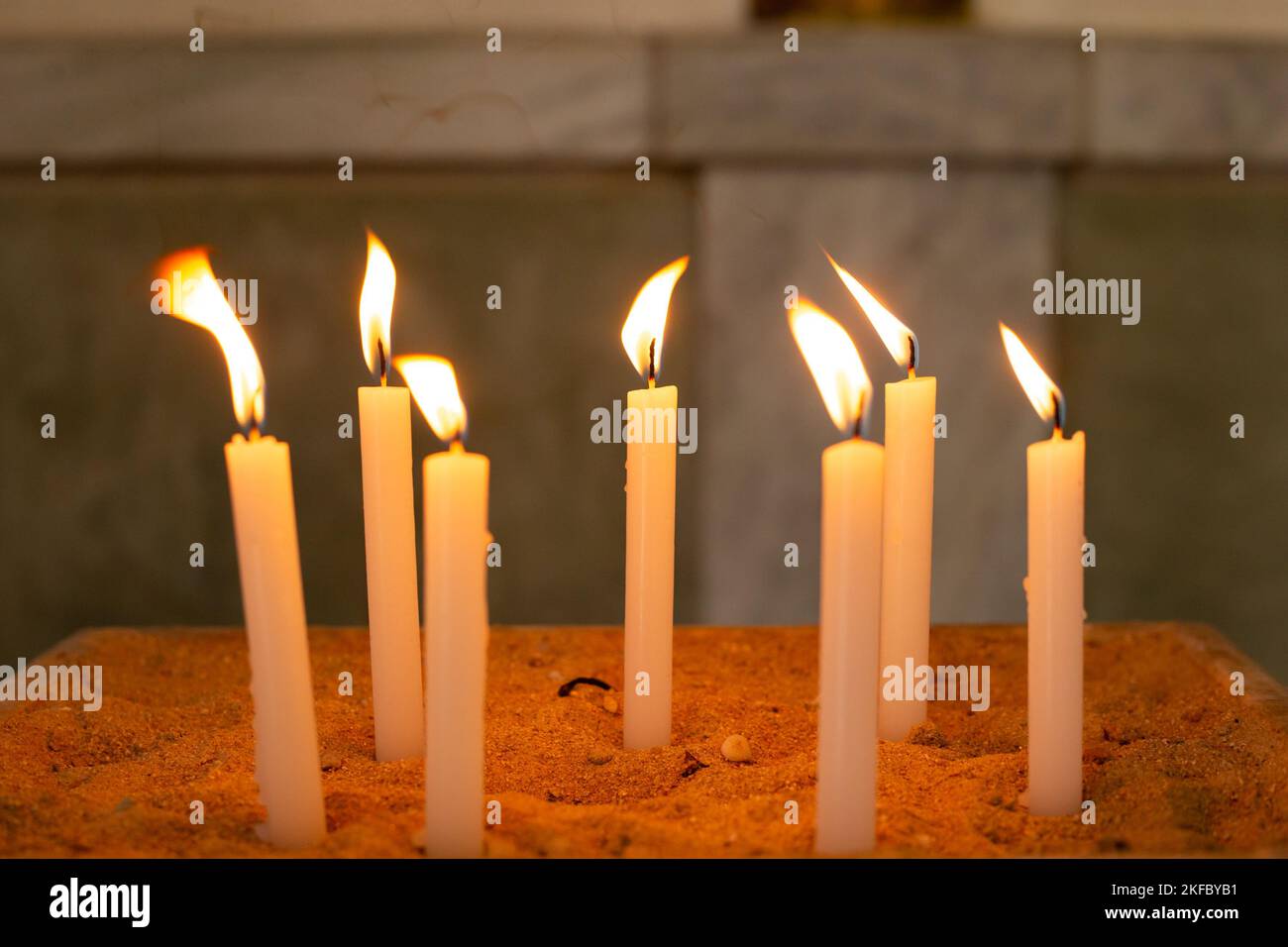 Goiânia, Goias, Brasile – 12 novembre 2022: Diverse candele accese in un porta-sabbia nella chiesa. Candele accese nel tempio, fuoco santo. Foto Stock