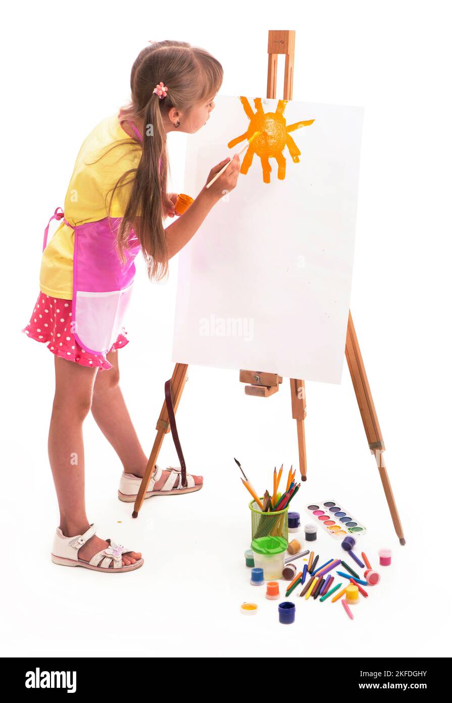 ragazza disegna una casa e il sole. artista ragazza capretto pittura su sfondo bianco Foto Stock
