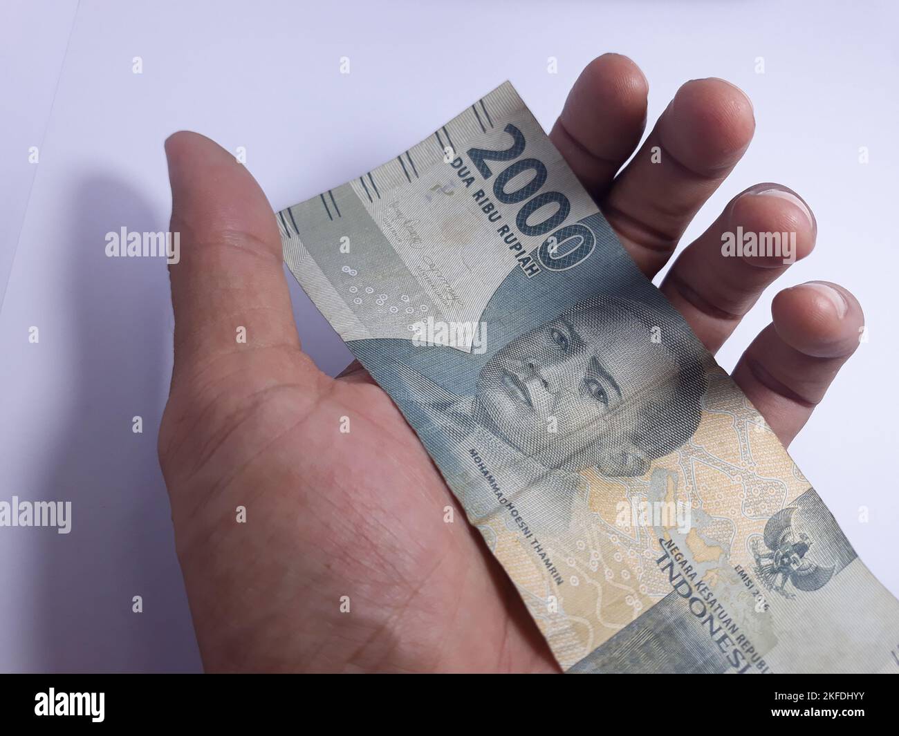 Primo piano isolato sulla mano bianca in possesso di denaro diverse banconote denominate in rupiah. Rupiah è la valuta dell'Indonesia Foto Stock Primo piano isolato sulla mano bianca in possesso di denaro diverse banconote denominate in rupiah. Rupiah è la valuta dell'Indonesia Foto Stock
