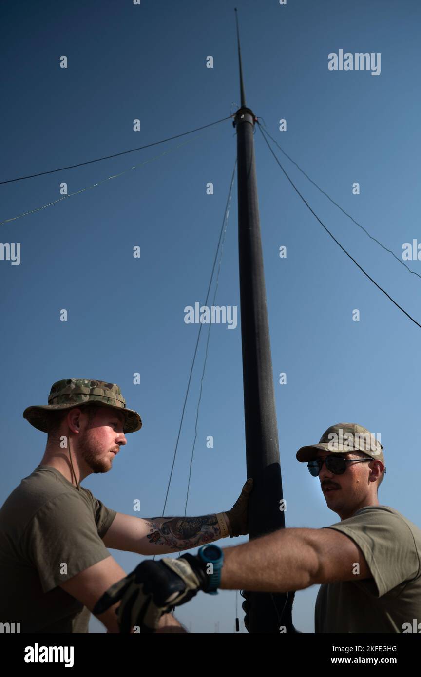 U.S. Air Force Senior Airman Devin Blount, 386th Expeditionary Communications Squadron e Senior Airman Daniel Stricker, 386th ECS radio Frequency Transmission Technician Hold on to a Mast Communication System mentre Airmen ha impostato delle puntate per mantenere il sistema in posizione durante l'operazione Agile Spartan III in una posizione non divulgata, settembre 12, 2022. Il sistema di comunicazione MAST è un sistema di comunicazione portatile che può essere configurato da un minimo di tre Airmen per rafforzare rapidamente le comunicazioni. Foto Stock