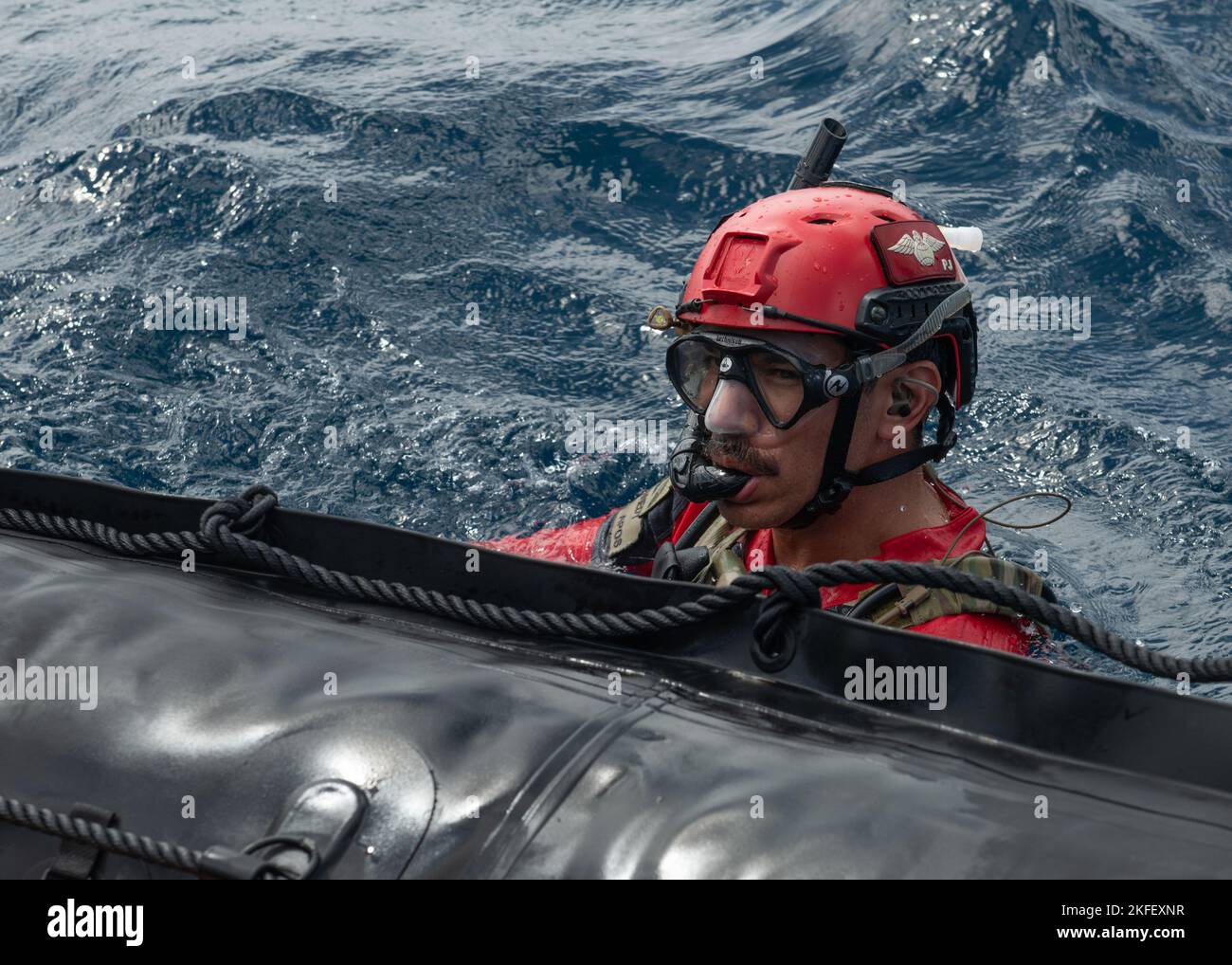 Un paraselareman dell'aeronautica degli Stati Uniti assegnato al 31st Rescue Squadron nuota accanto a un'imbarcazione da combattimento in gomma durante un addestramento di ricerca e salvataggio nell'Oceano Pacifico, 13 settembre 2022. Le PJ sono addestrate, attrezzate e preparate per condurre operazioni di recupero del personale a tutto spettro in ambienti di pace e combattimento. Foto Stock