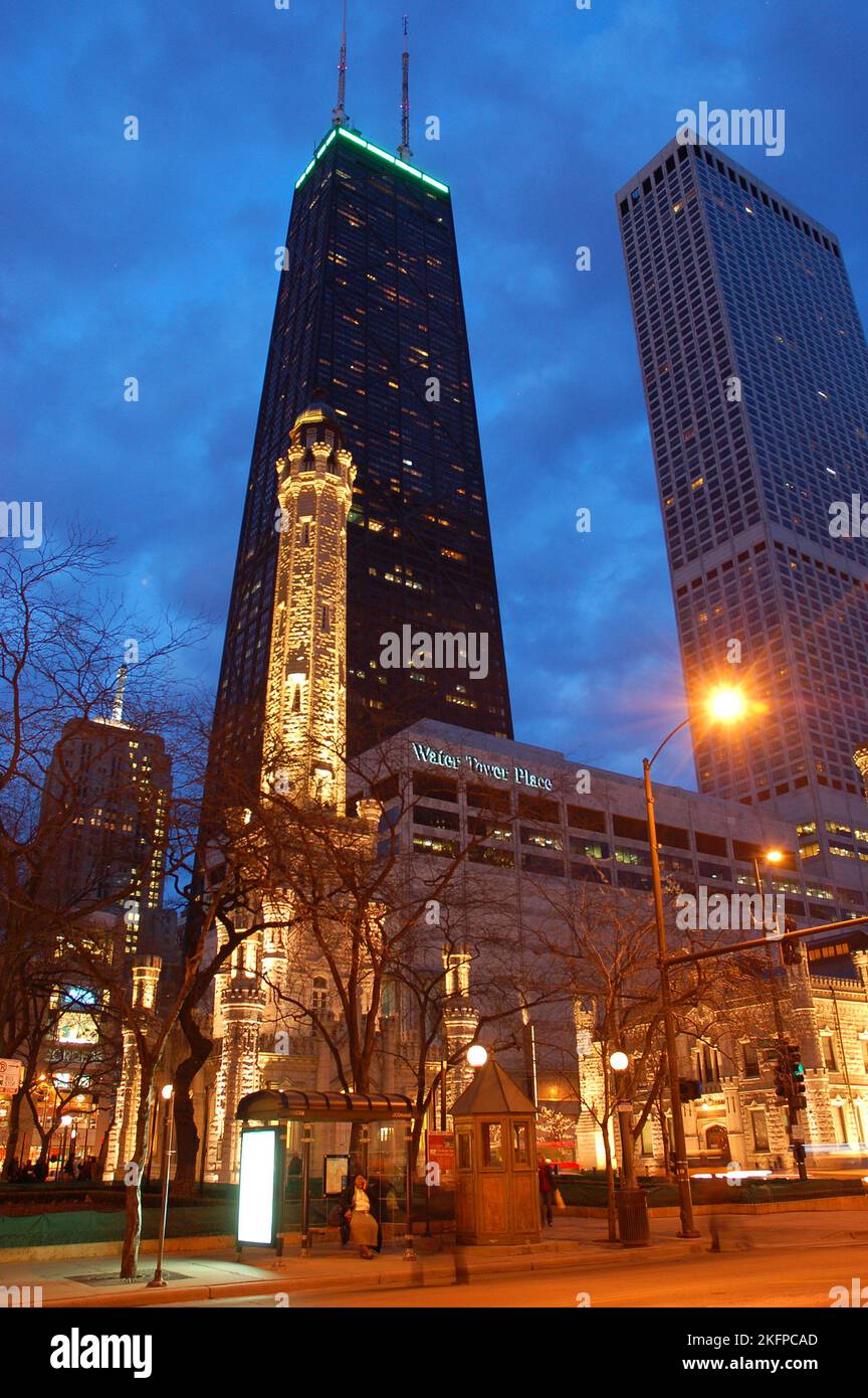 La storica Water Tower, uno dei pochi Survivor del fuoco di Chicago, si trova tra i moderni grattacieli lungo Michigan Avenue di notte Foto Stock