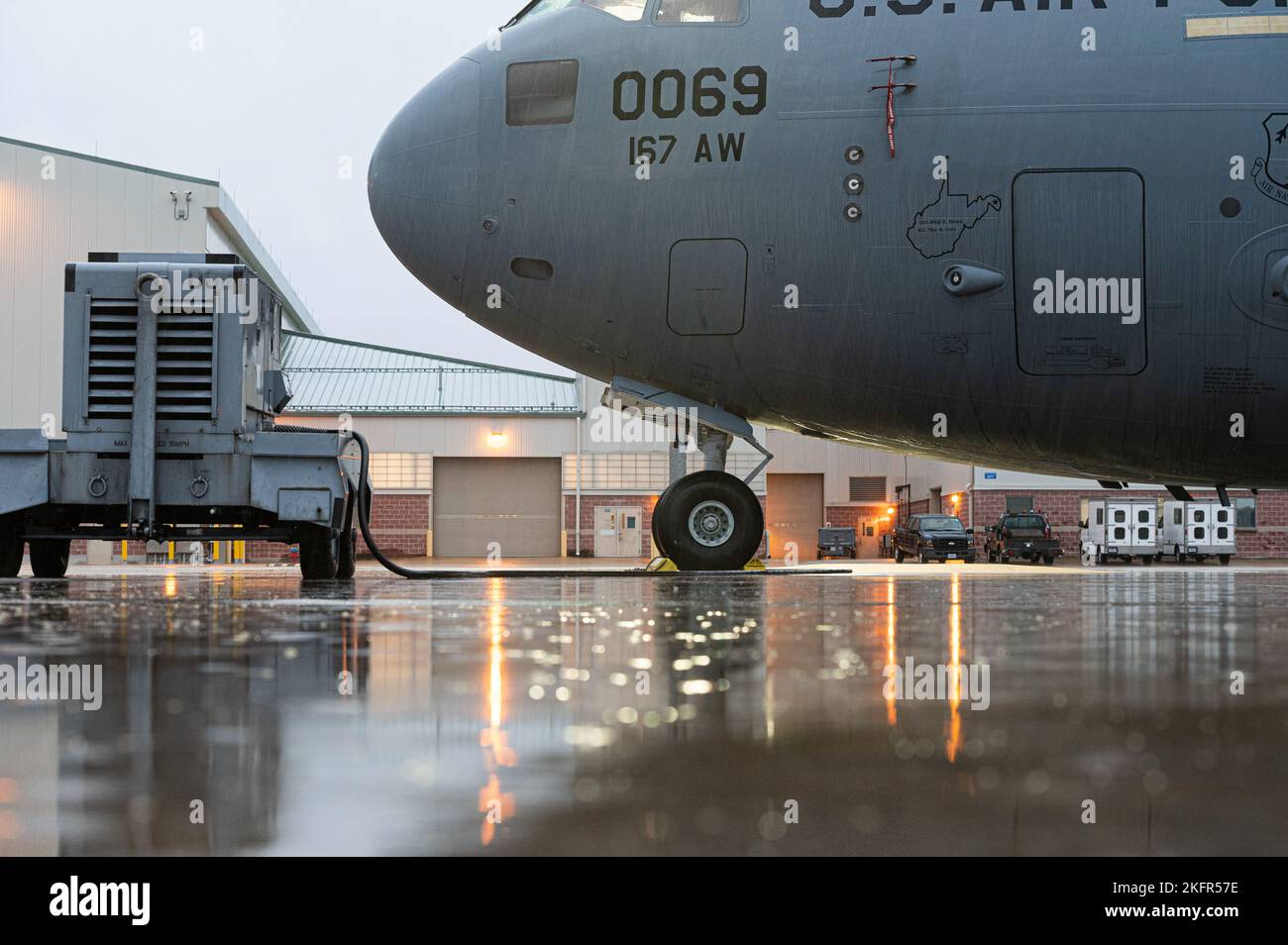 La luce riflette la pioggia sul asfalto di prima mattina presso l'Ala 167th Airlift, Martinsburg, West Virginia, 2 ottobre 2022. I resti dell’uragano Ian sono passati attraverso l’area creando lunghi periodi di docce durante l’assemblaggio dell’unità di addestramento dell’ala di ottobre. Foto Stock