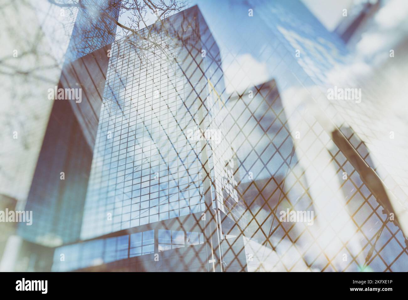 Sfondo urbano astratto di grattacieli di vetro con cielo riflesso nelle finestre, texture, foto a doppia esposizione Foto Stock