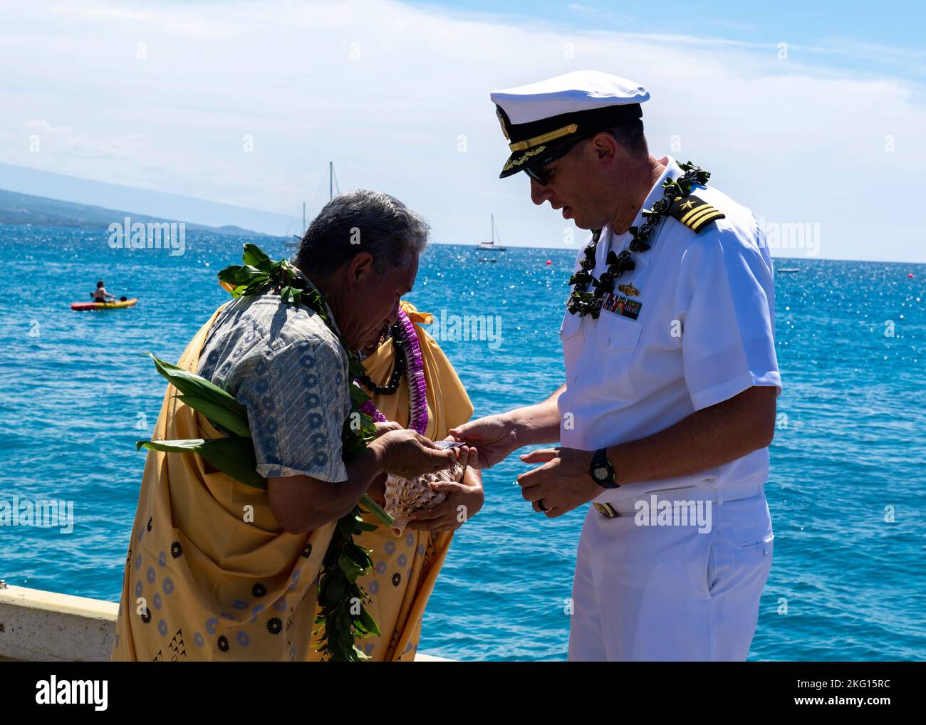 221021-N-OA516-1217 KAILUA-KONA, HAWAII (OTT 21, 2022) – CMdR. Kevin Dore, ufficiale esecutivo del cacciatorpediniere missilistico guidato della classe Arleigh-Burke USS Daniel Inouye (DDG 118), presenta una moneta di sfida a Daniel Akaka, durante una visita al porto programmata a Kailua-Kona. Daniele e sua moglie Anna hanno eseguito una benedizione sul molo per i membri dell’equipaggio della nave, accogliendoli per la prima volta nell’isola delle Hawaii. Foto Stock