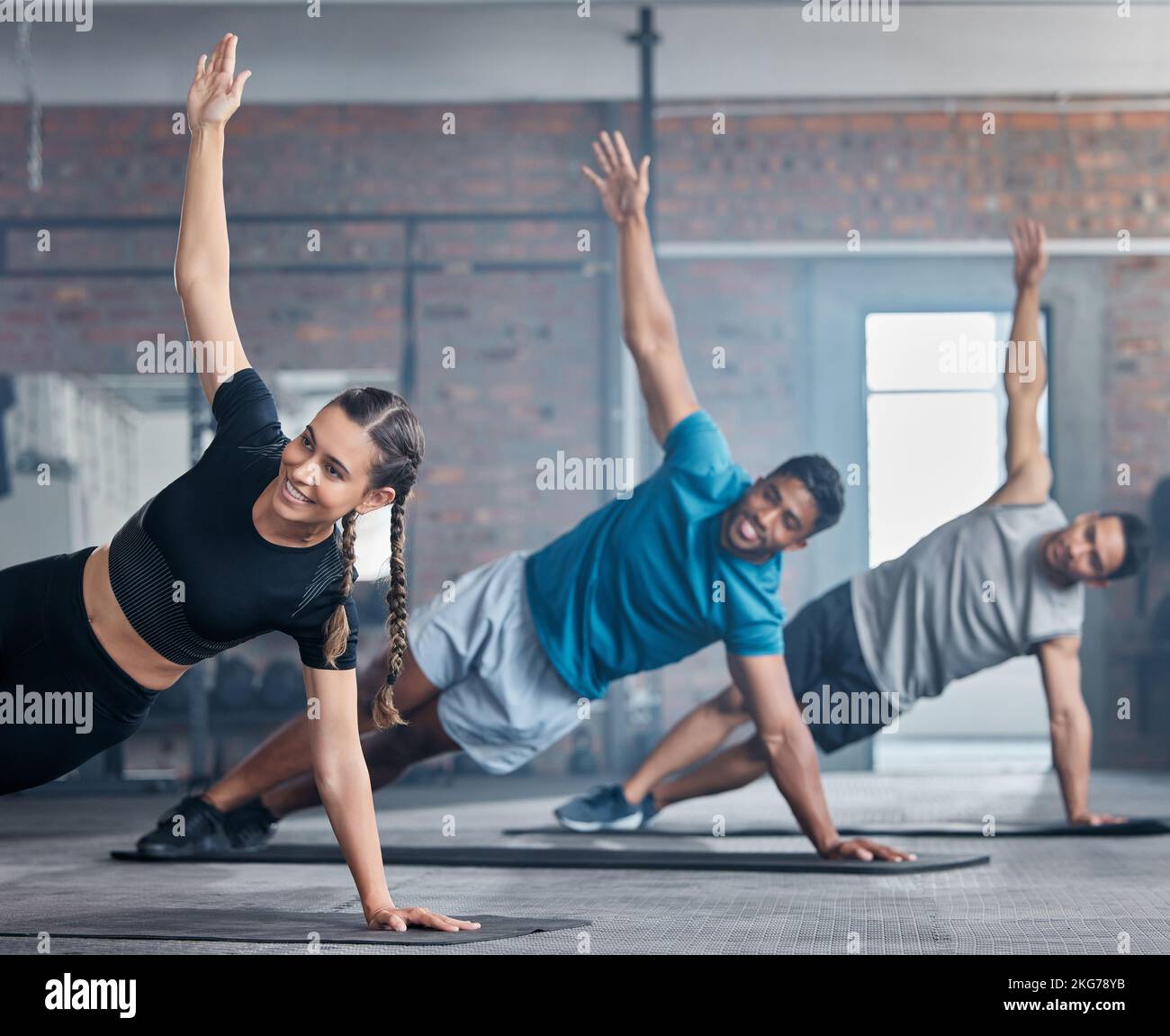 Fitness, squadra e braccia stretching per allenarsi, allenarsi o allenarsi insieme al sorriso in palestra. Persone attive in una classe sportiva per il riscaldamento Foto Stock