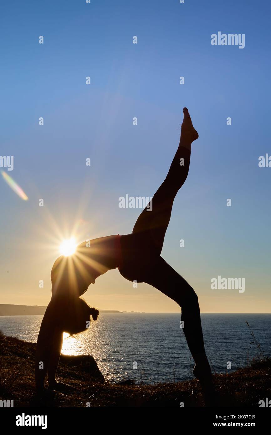 Iyengar invertito posizione yoga in natura con donna attraente Foto Stock