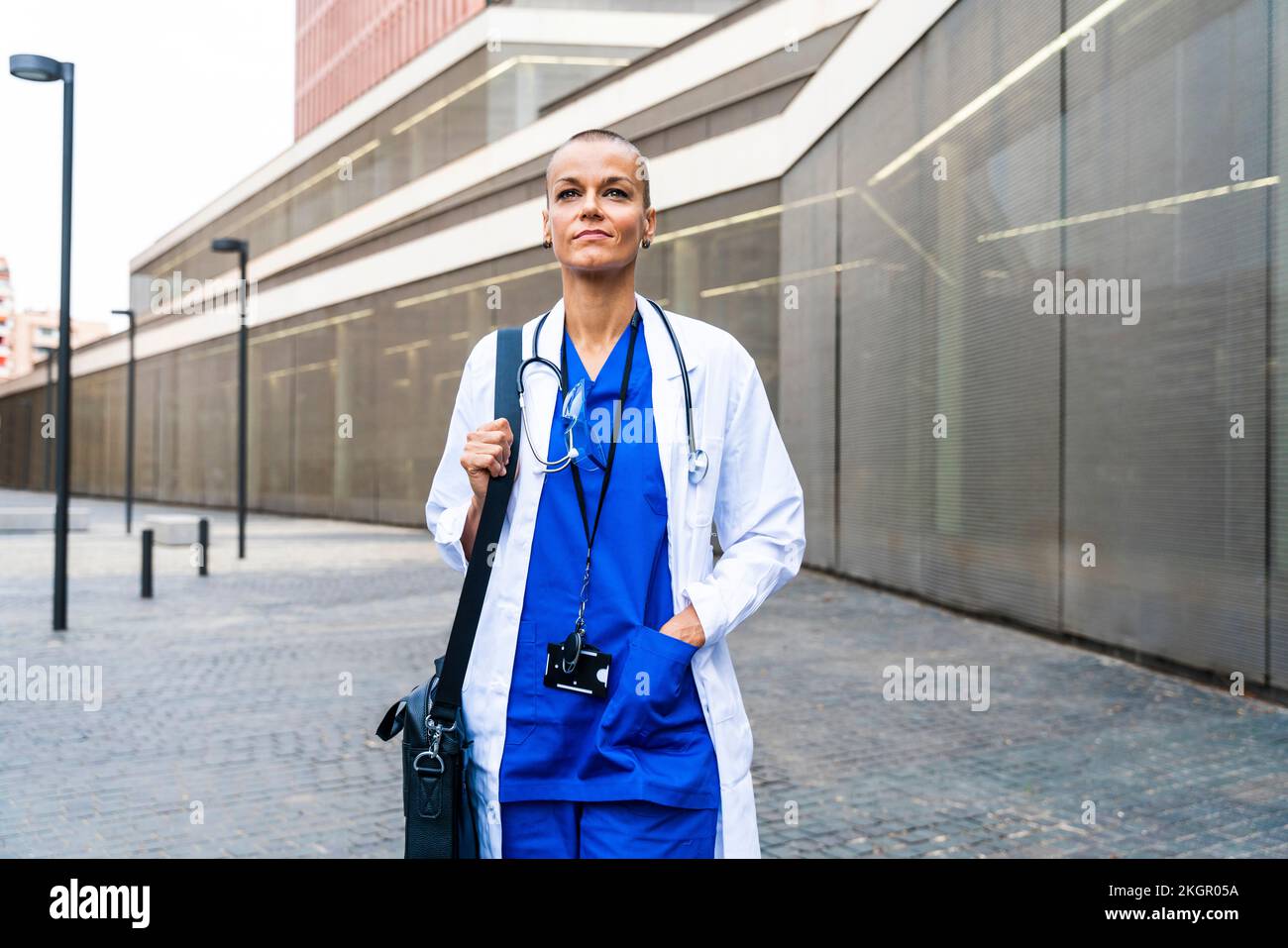 Medico premuroso con borsa a spalla che cammina sul sentiero Foto Stock