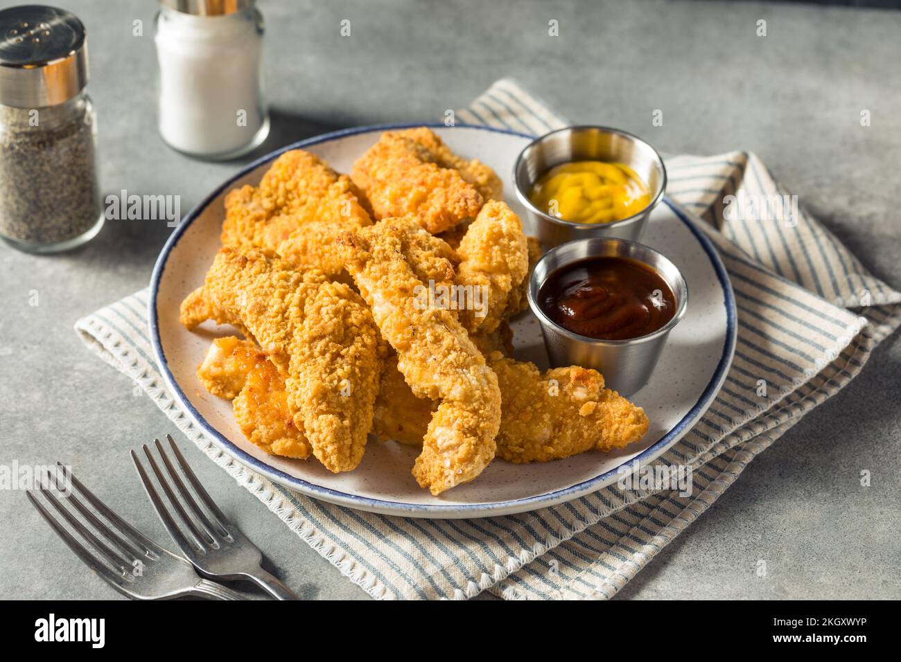 Strisce di pollo fritto con senape e barbecue fatte in casa Foto Stock